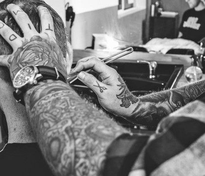 barber shaves man's edge